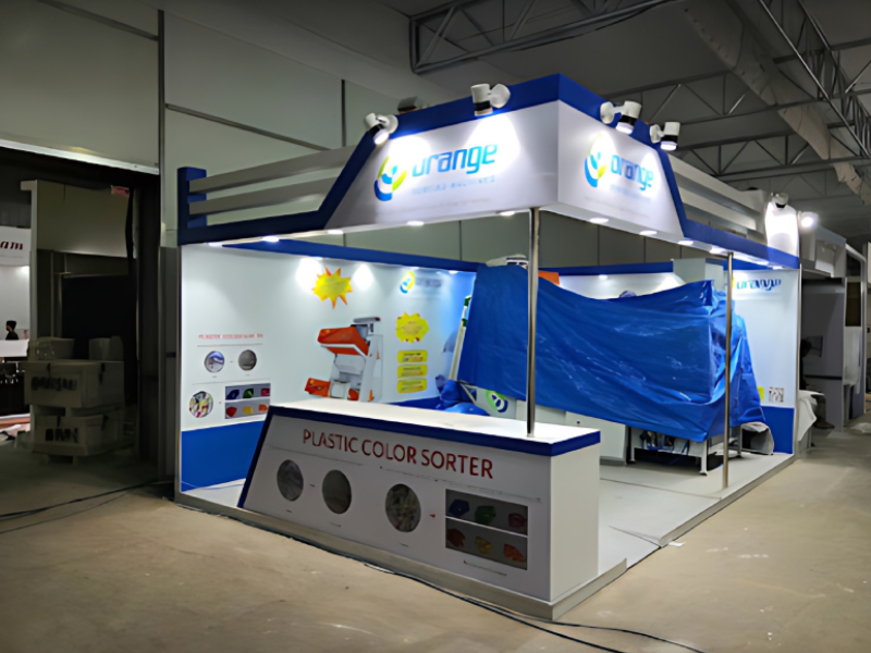 Custom Exhibition Stand Fabrication And Plastic Sorting Equipment Showcase Service For Recycling Industry Orange